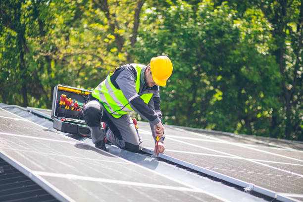 a worker is using tools to install solar panels a worker is using tools to install solar panels